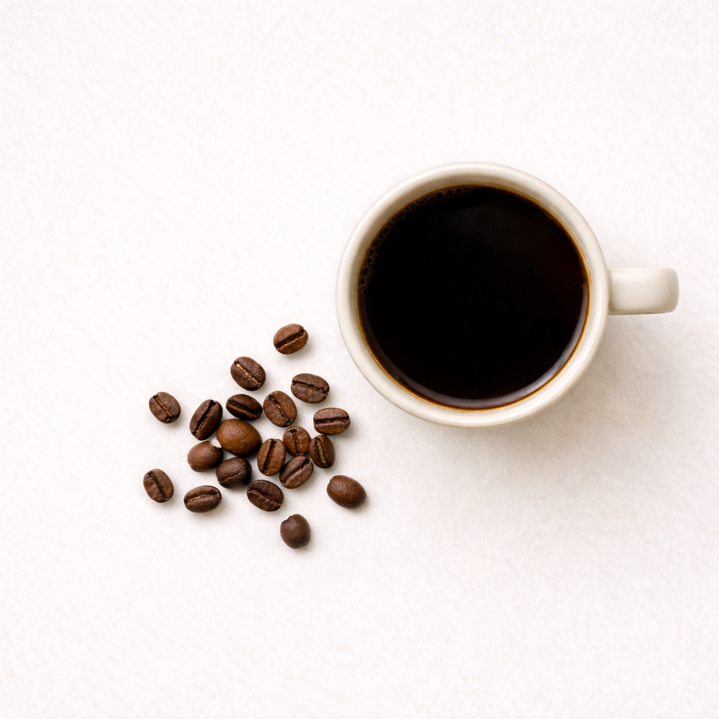 Cup of coffee and coffee beans on a white background